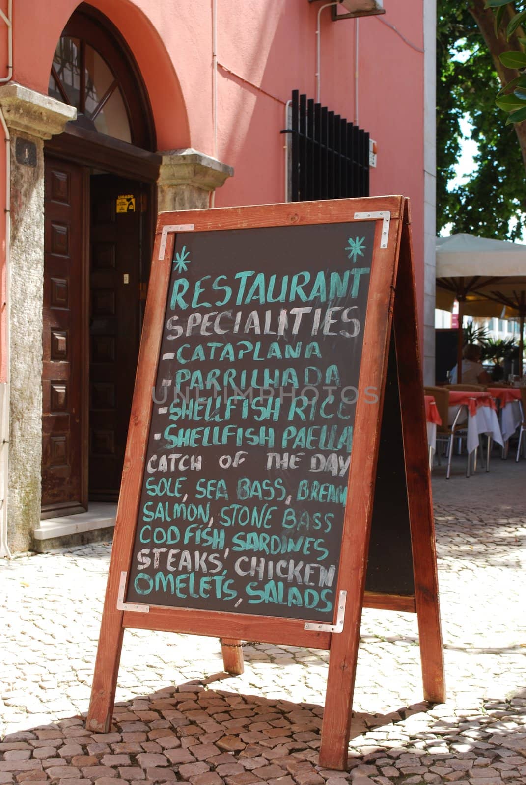 restaurant ad with a chalkboard menu in a local street