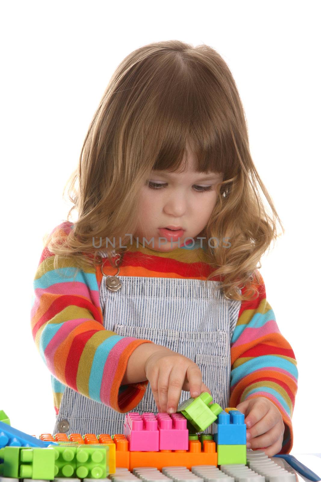 girl playing colorful building toy blocks  by vladacanon