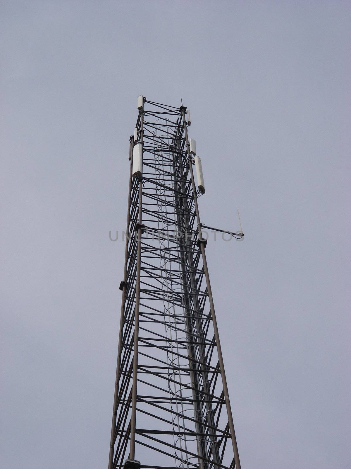 portrait closeup of endless communication-tower reach for sky on smooth background