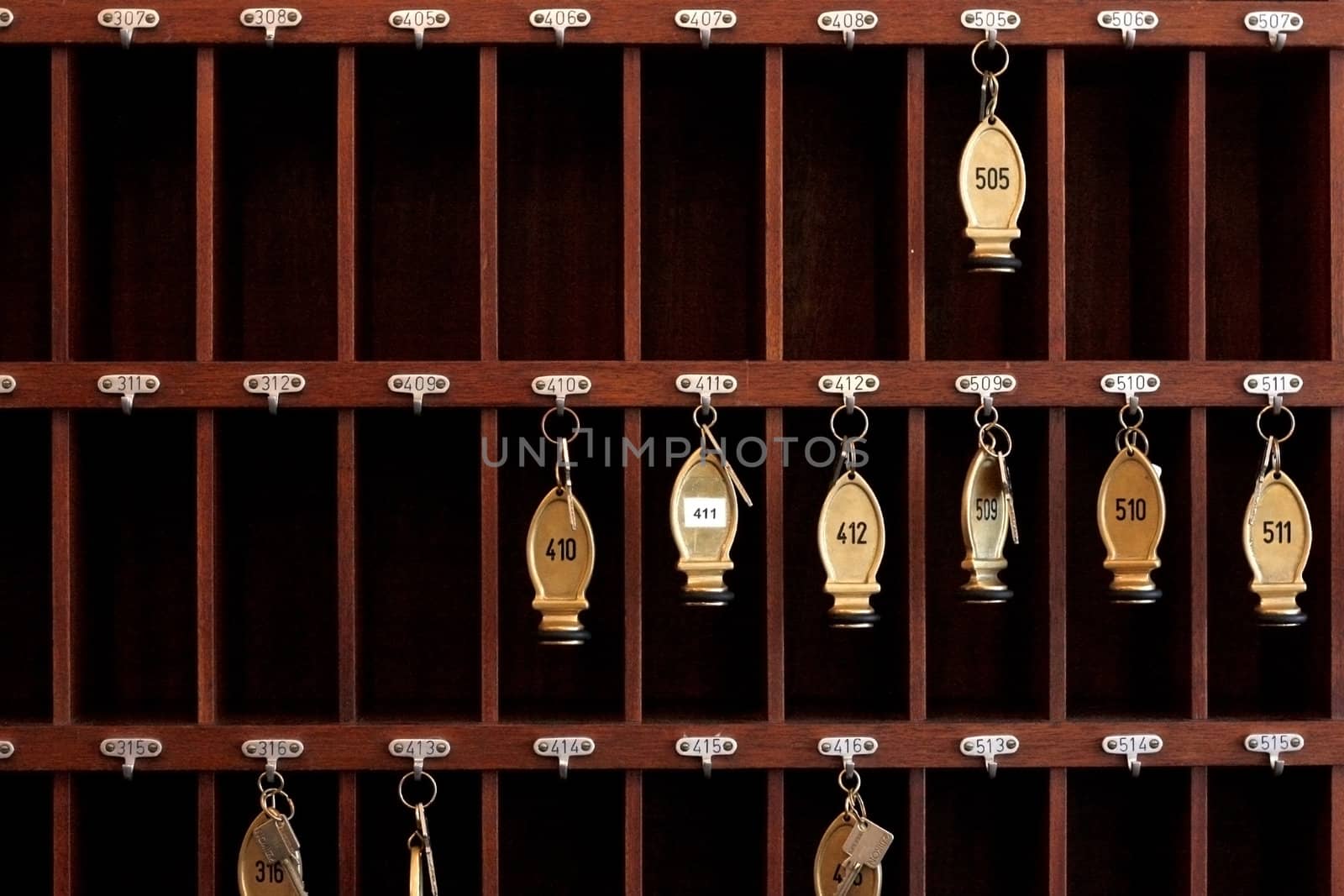 Several hotel keys in a cabinet