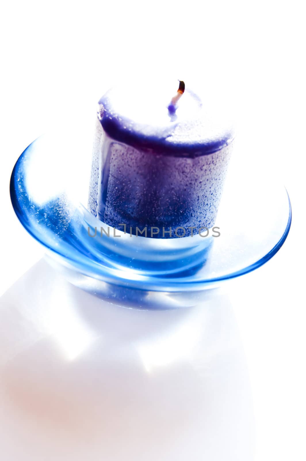 A fresh blue candle isolated on white