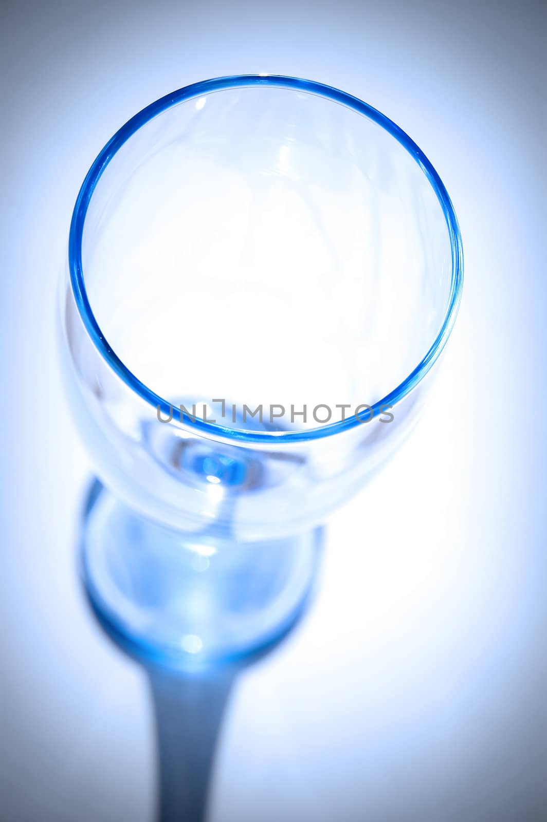 A blue glass seen by top illuminated and isolated on white