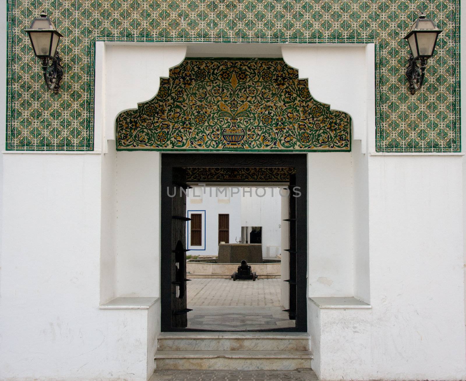 Tiled entrance to fort in Abu Dhabi in UAE with antique lamps
