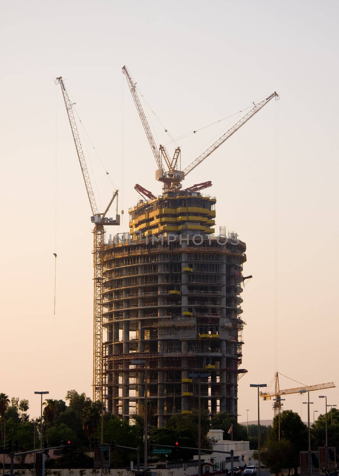 Framework of new office building in Abu Dhabi in UAE with cranes and construction