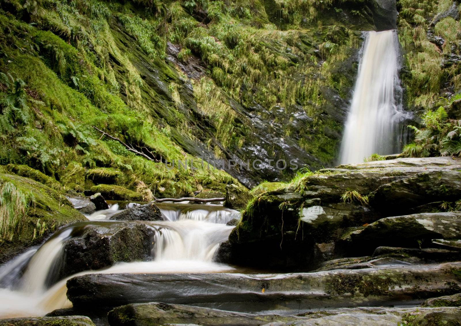 Close view of waterfall with rocks in the foreground