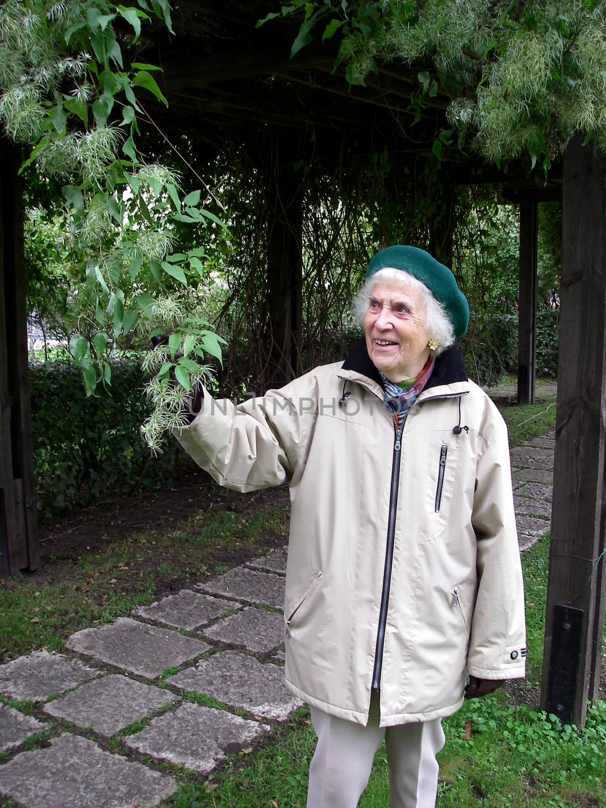 portrait of happy gardener woman showing plants in autumn