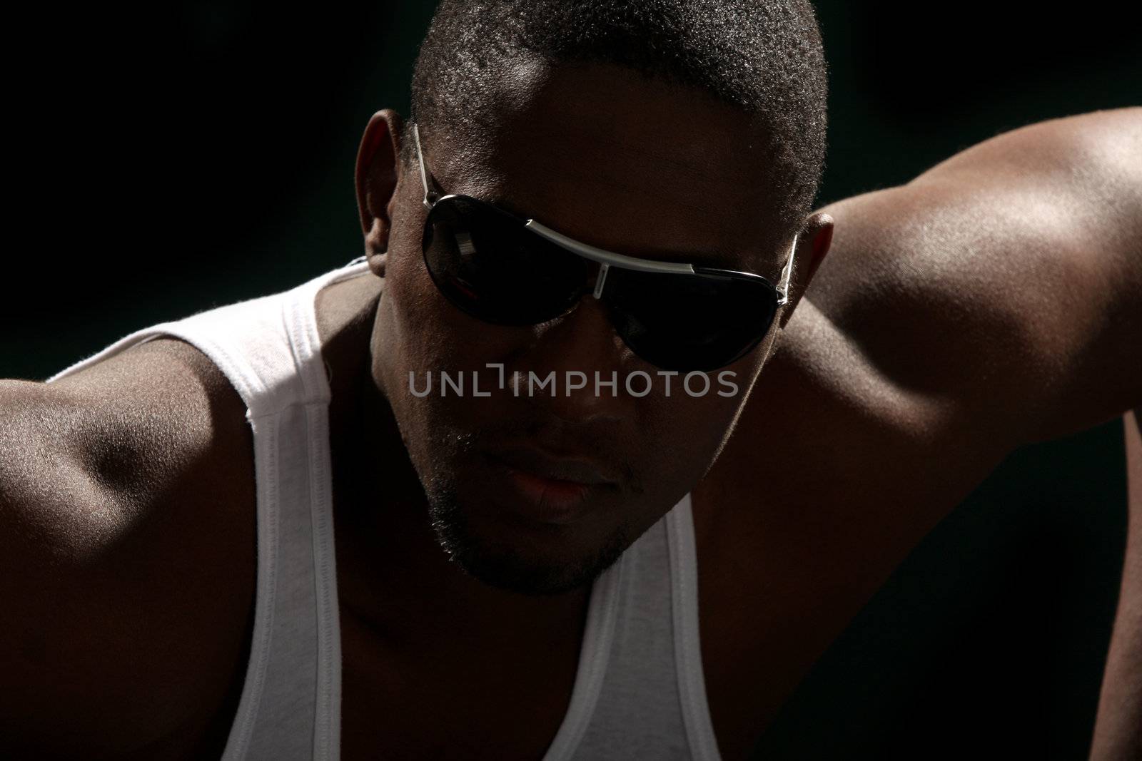 Young african american male on black background