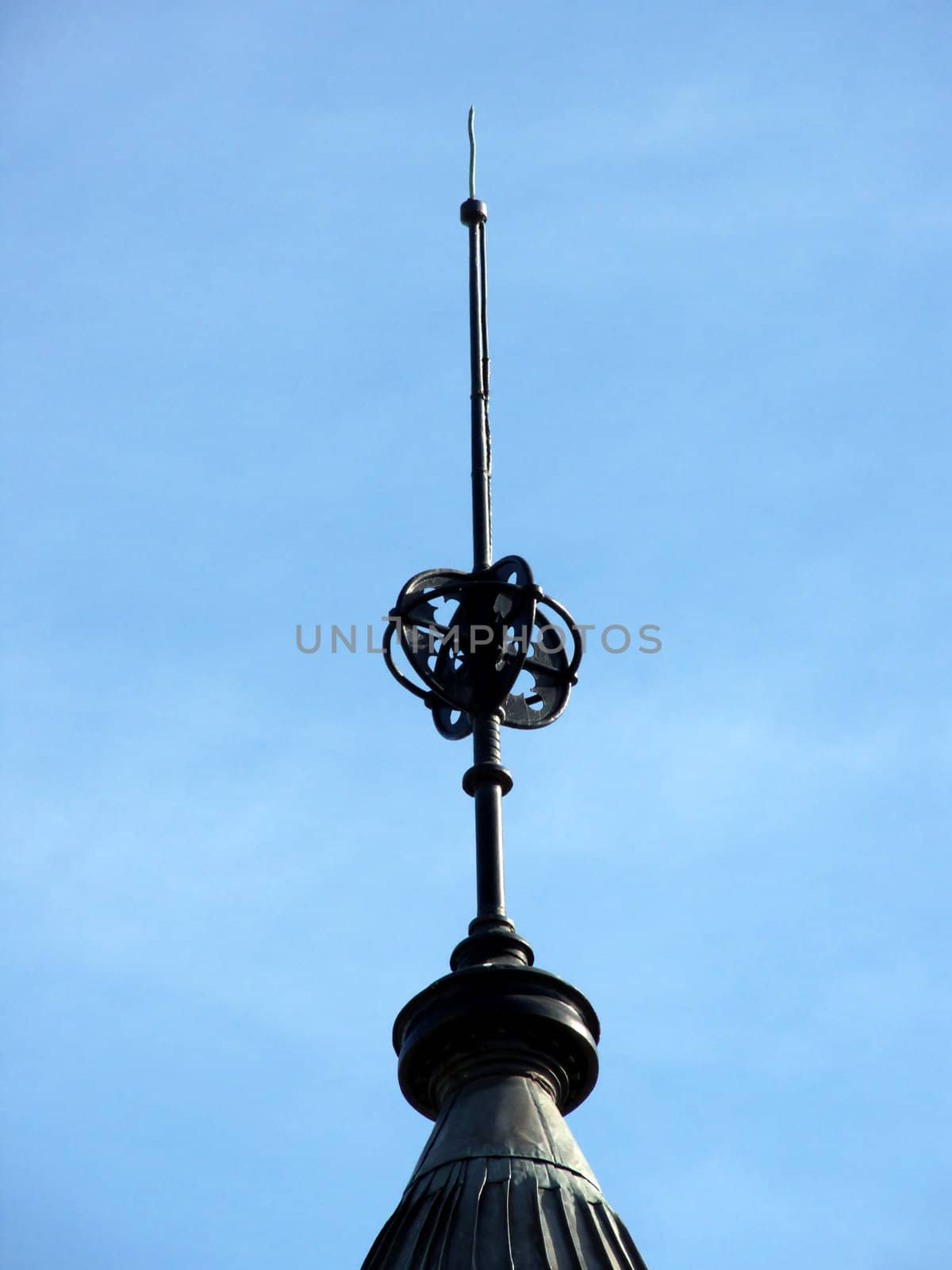 closeup portrait of spire on old building in blue sky
