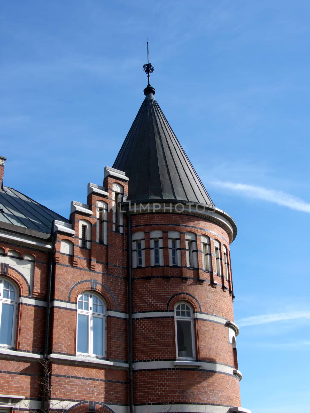 portrait of old building with tower in blue sky
