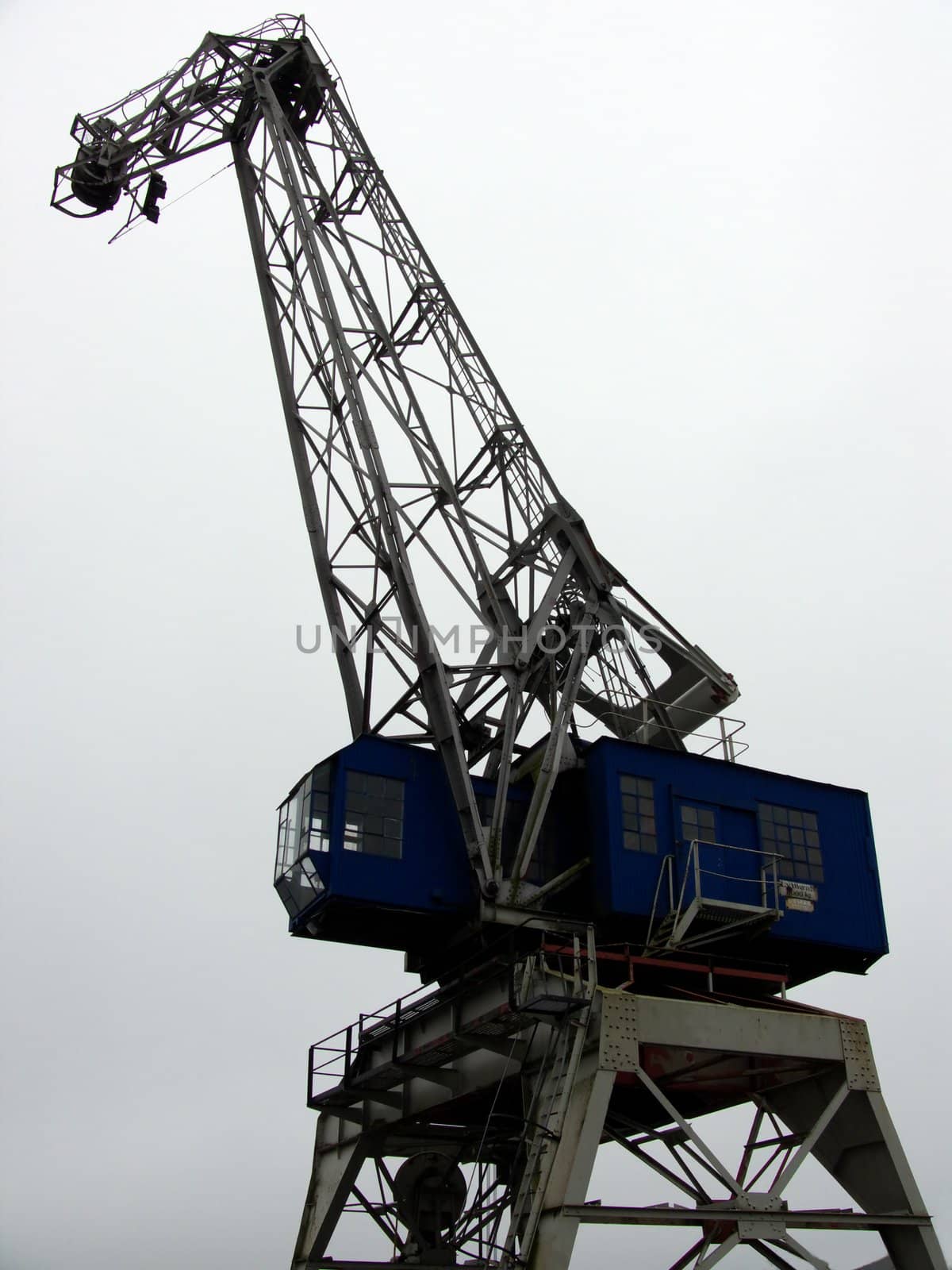 portrait of heavy old industry crane on gray background