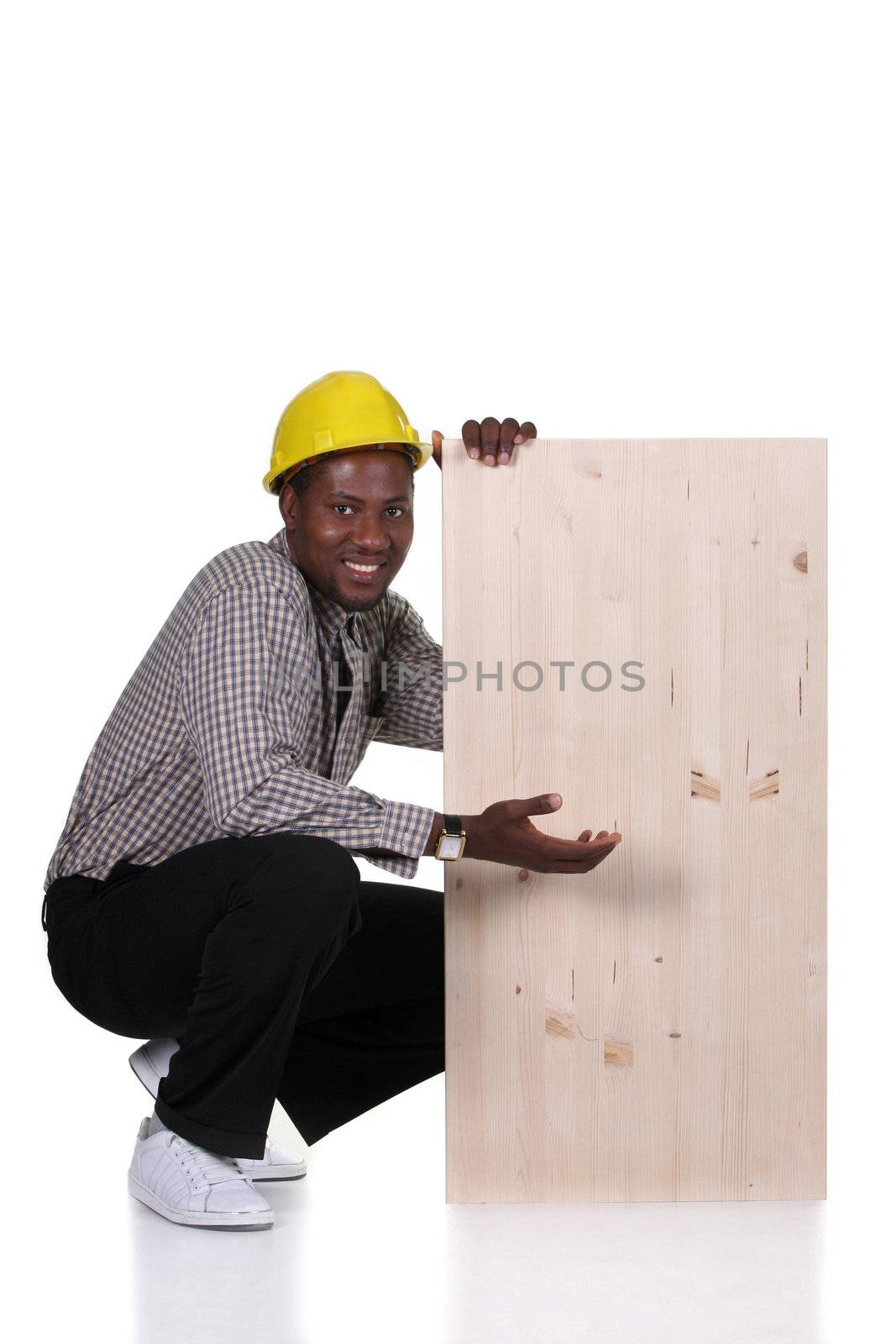 Young african american carpenter holding wooden plank on white background 