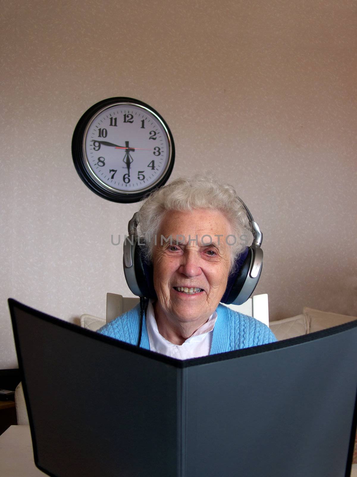 portrait of senior woman listening to music and holding notes