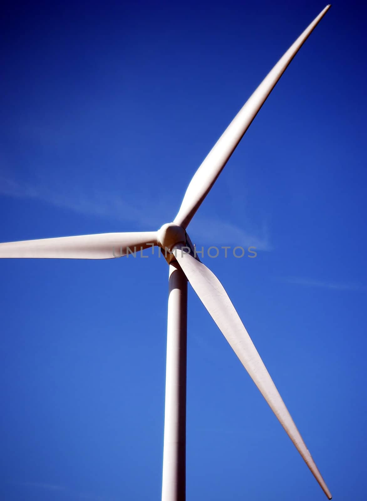 close-up portrait of wind turbine in blue sky