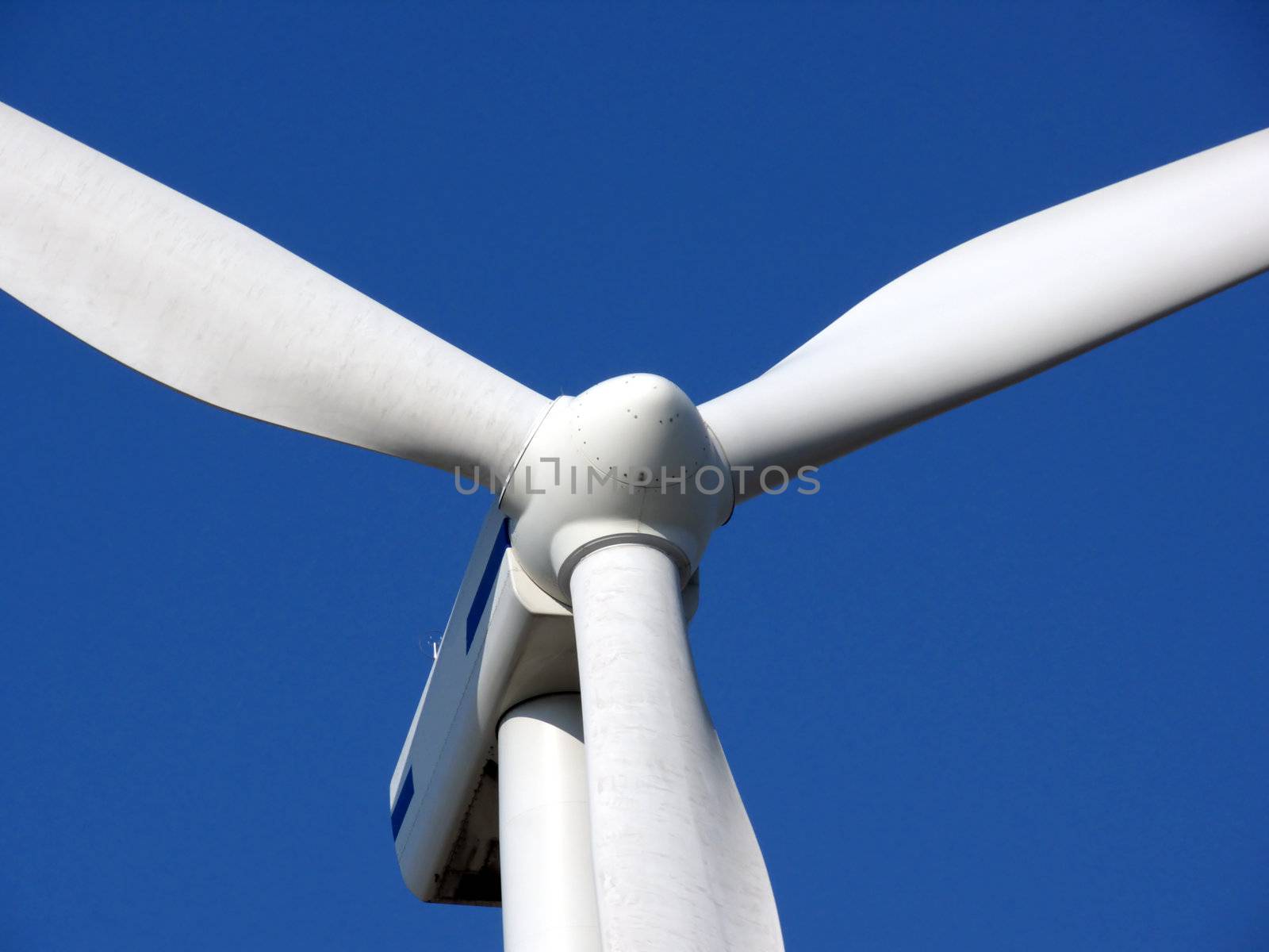 close-up portrait of wind turbine in blue sky
