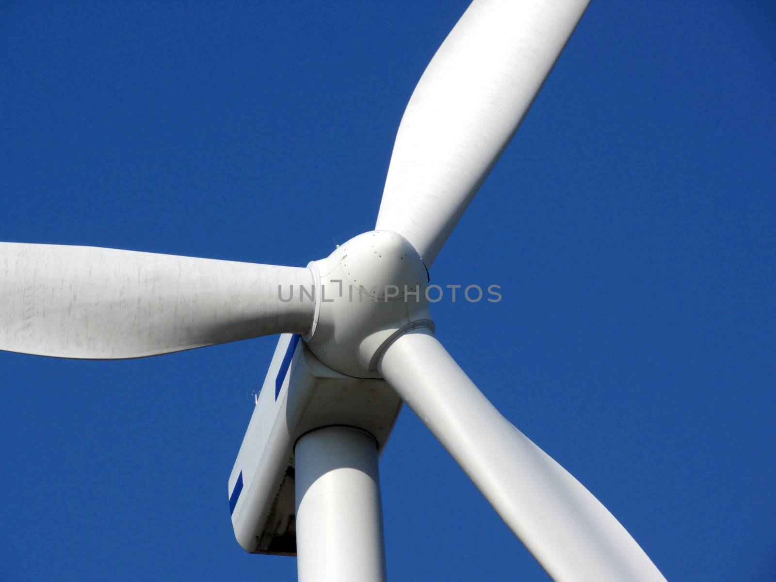 close-up portrait of wind turbine in blue sky