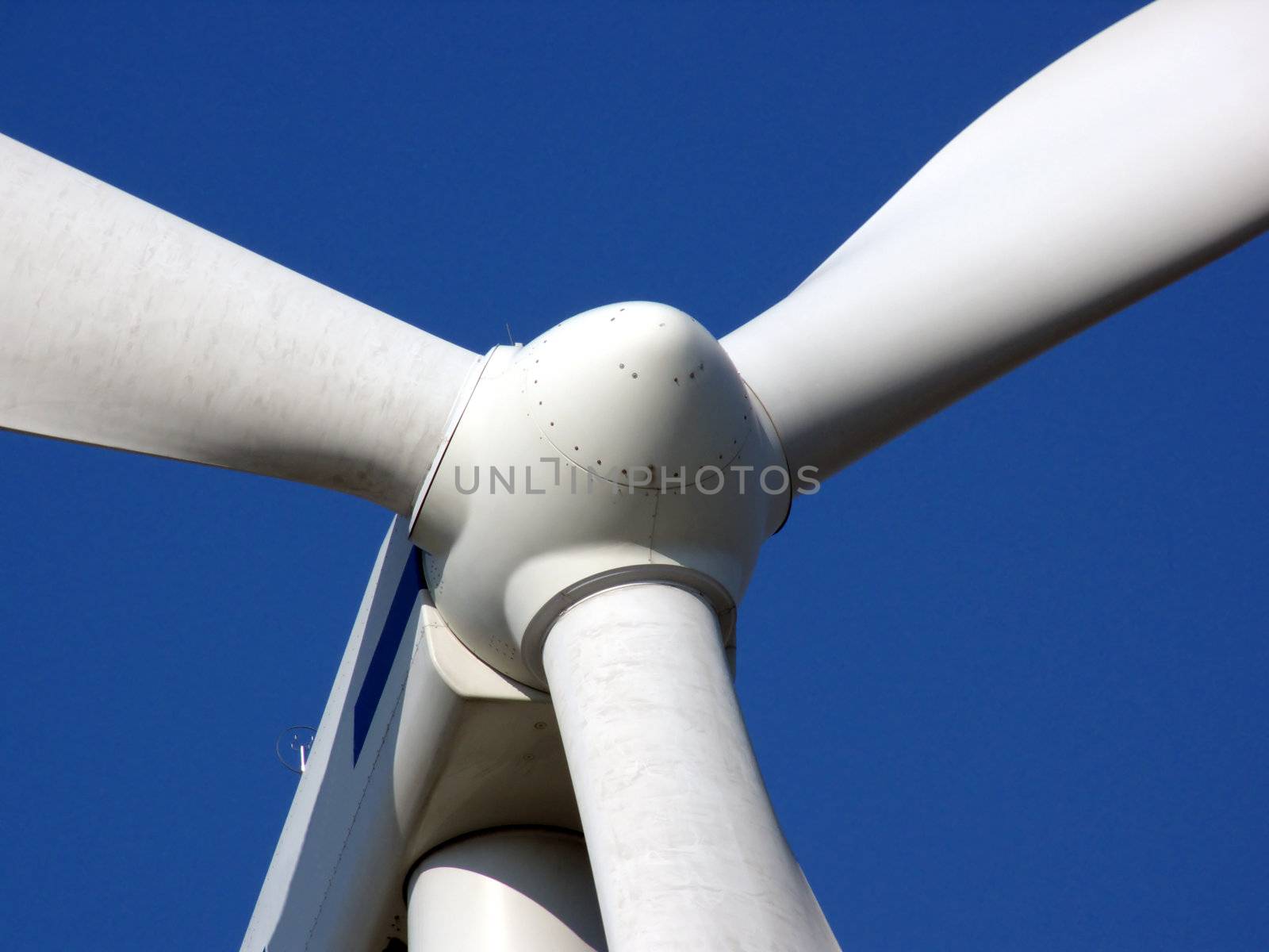 close-up portrait of wind turbine in blue sky