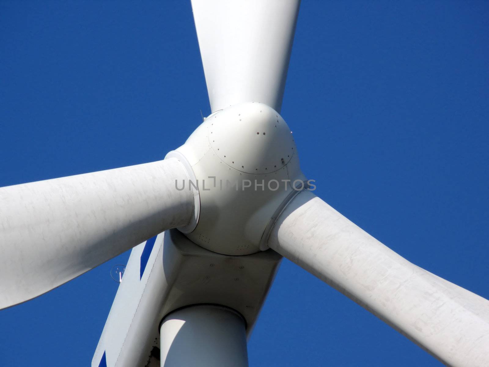 close-up portrait of wind turbine in blue sky