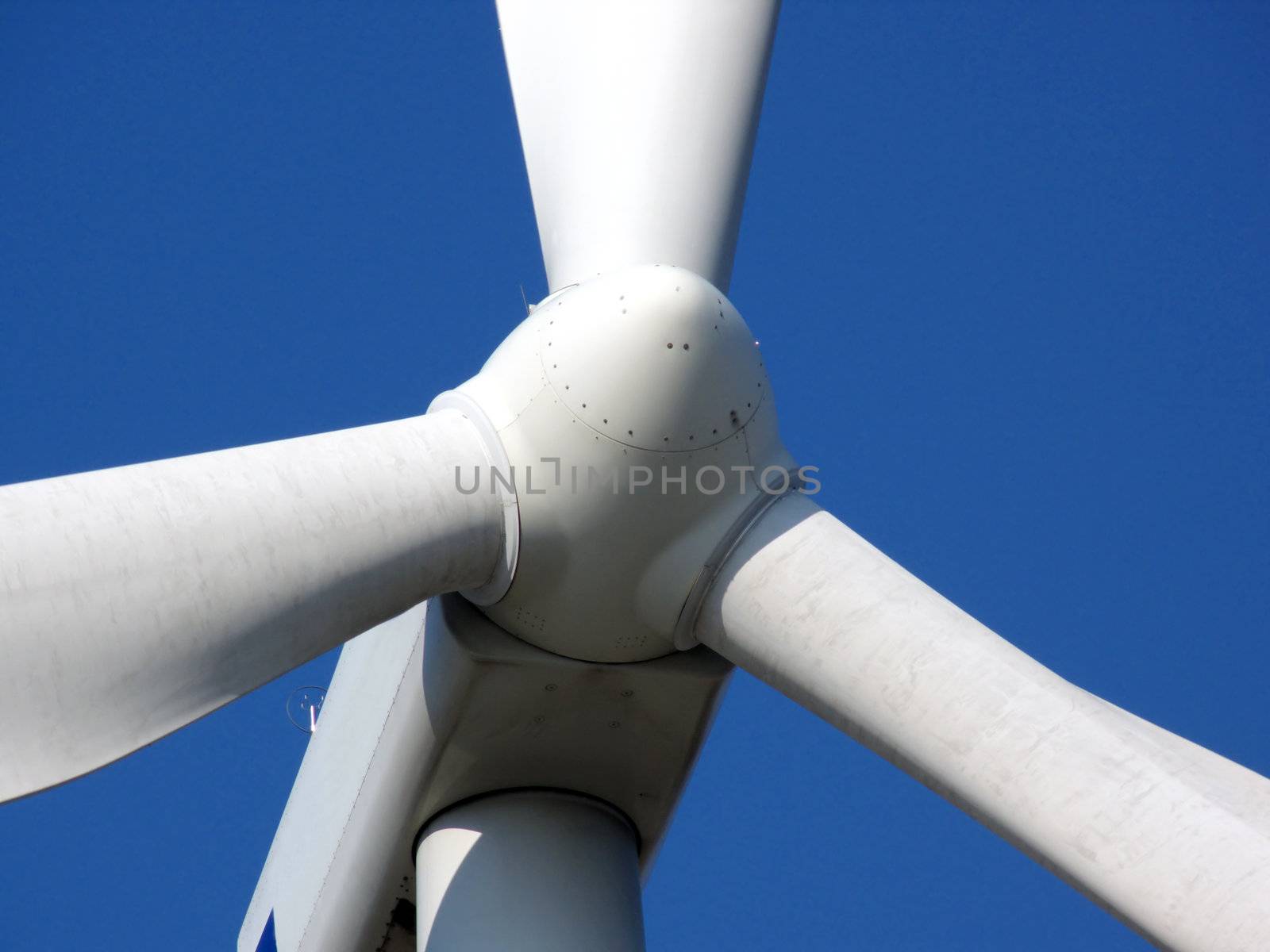 close-up portrait of wind turbine in blue sky