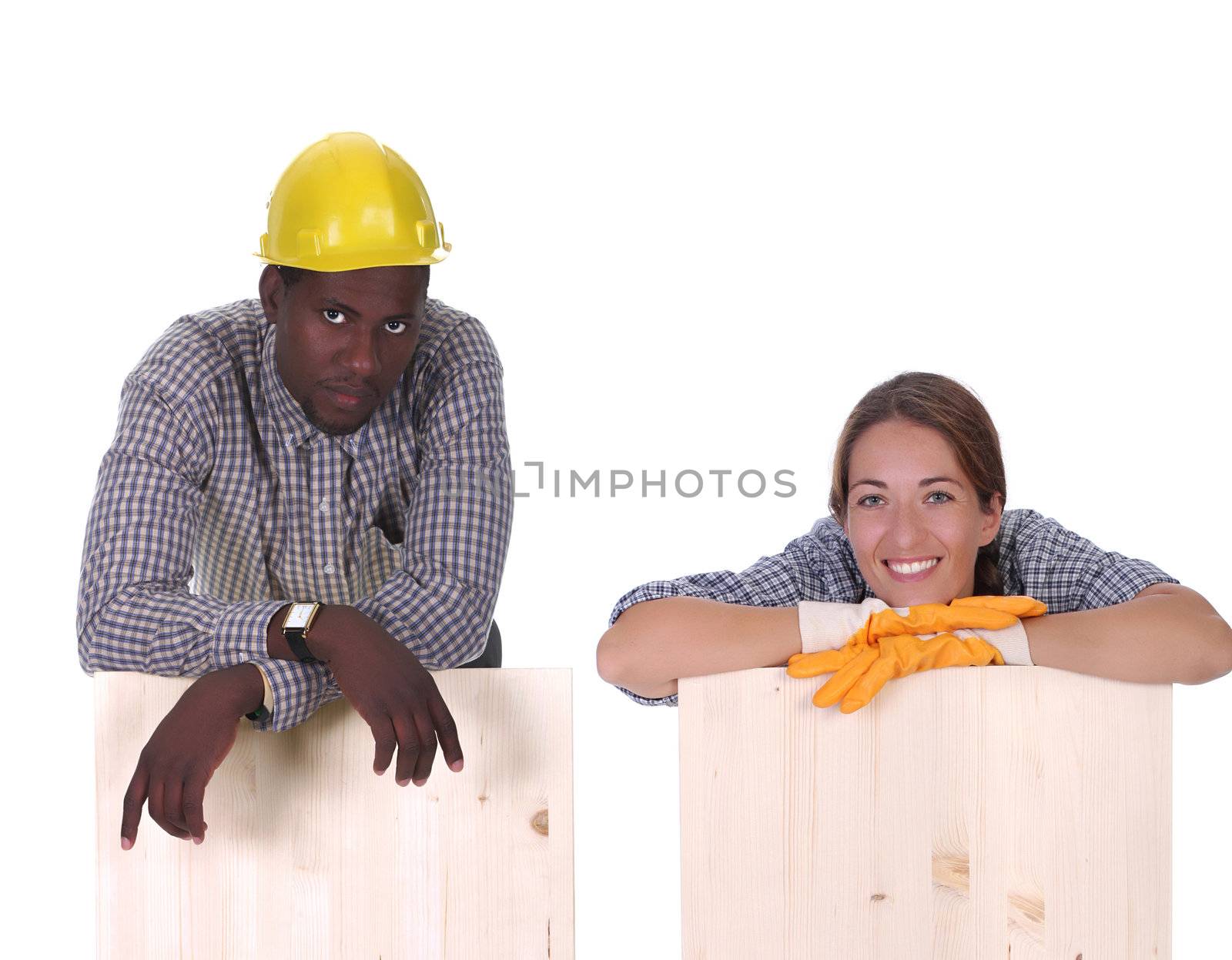 Young african american carpenter and woman carpenter holding wooden plank 