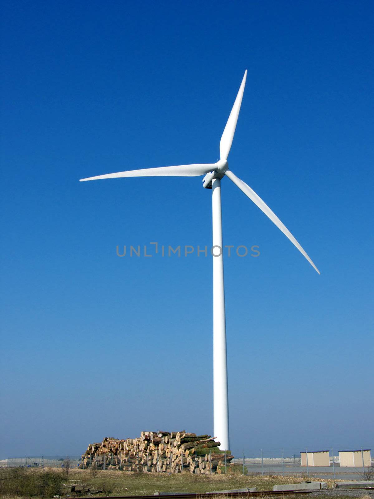 portrait of wind turbine in blue sky