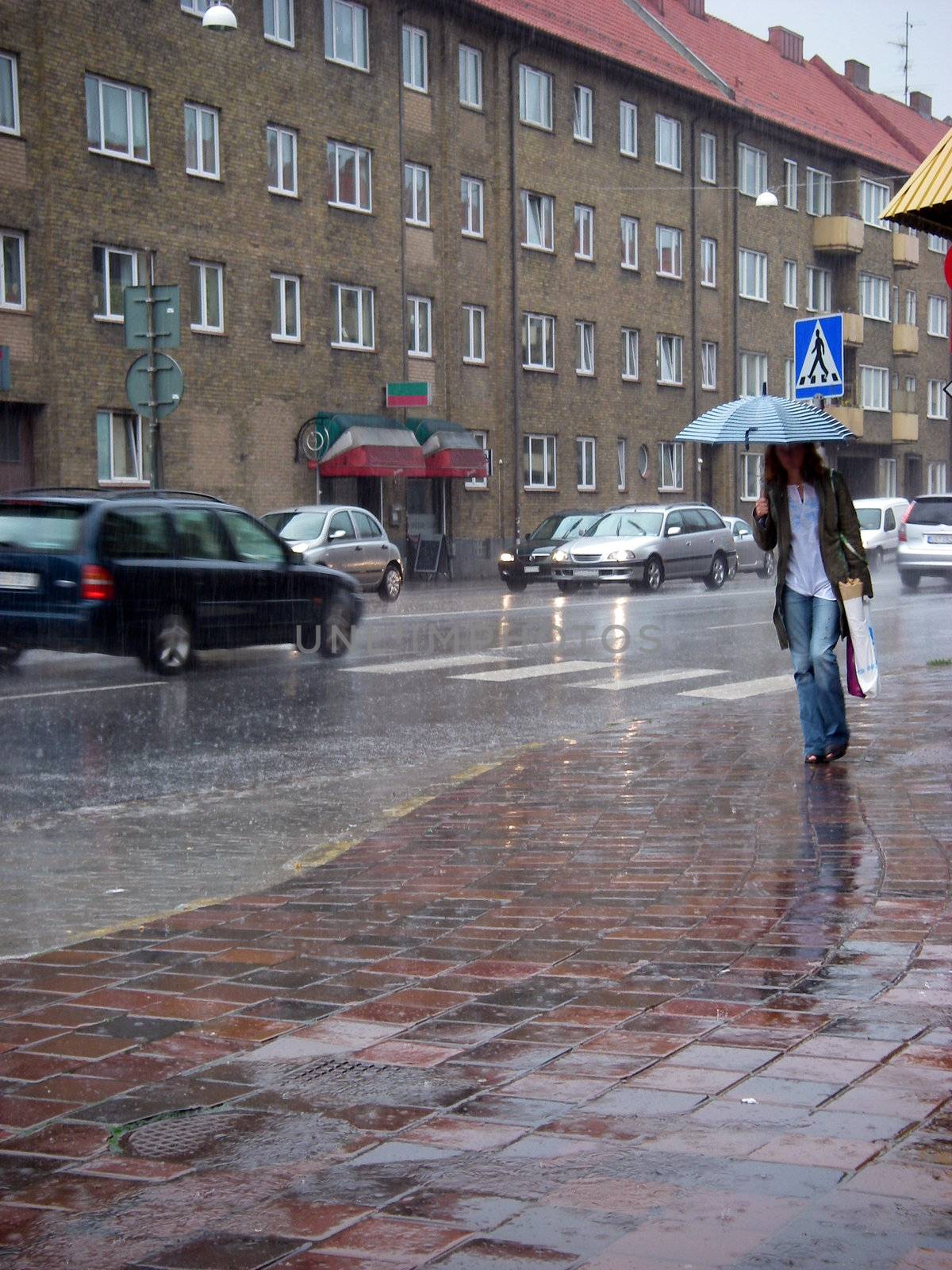 portrait of shopping woman and cars passing street a rainy day in city