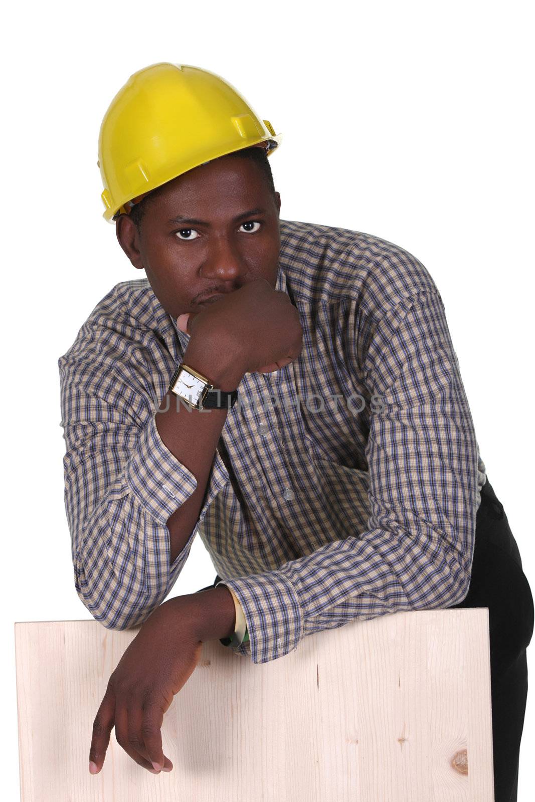 Young african american carpenter holding wooden plank on white background 