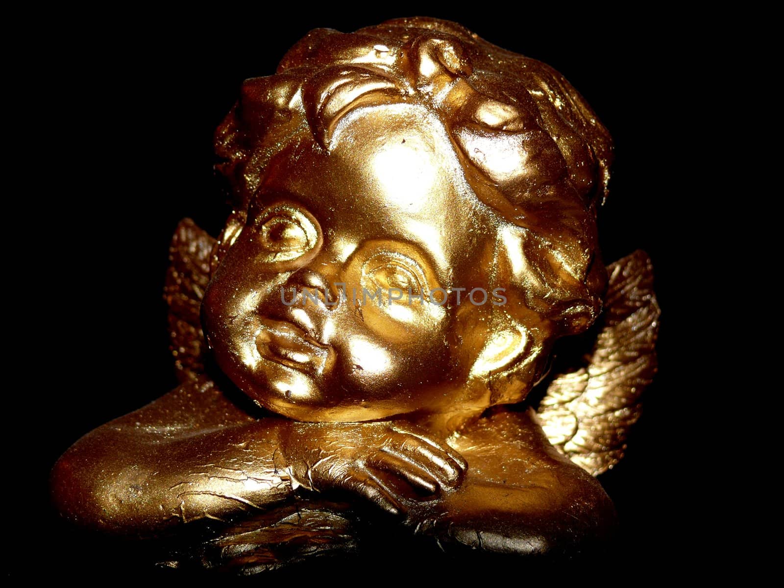 portrait of angel in gold statue on black background