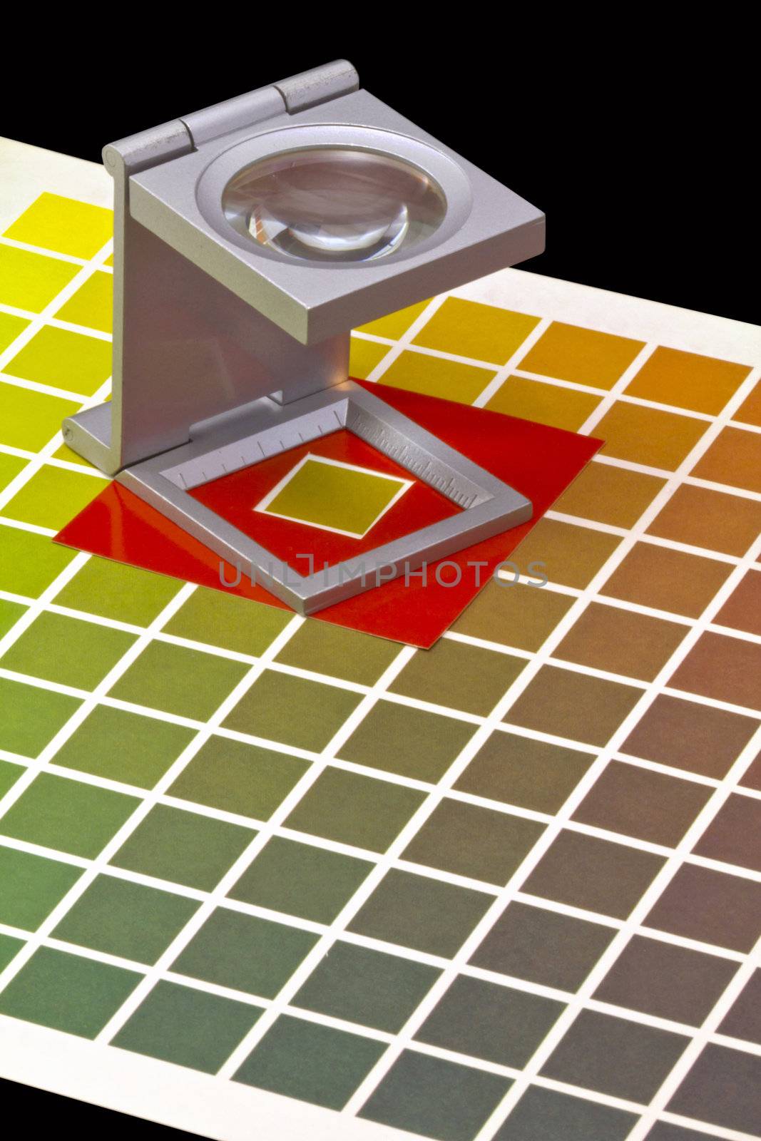 Color guide for offset print with a magnifier lens over the table