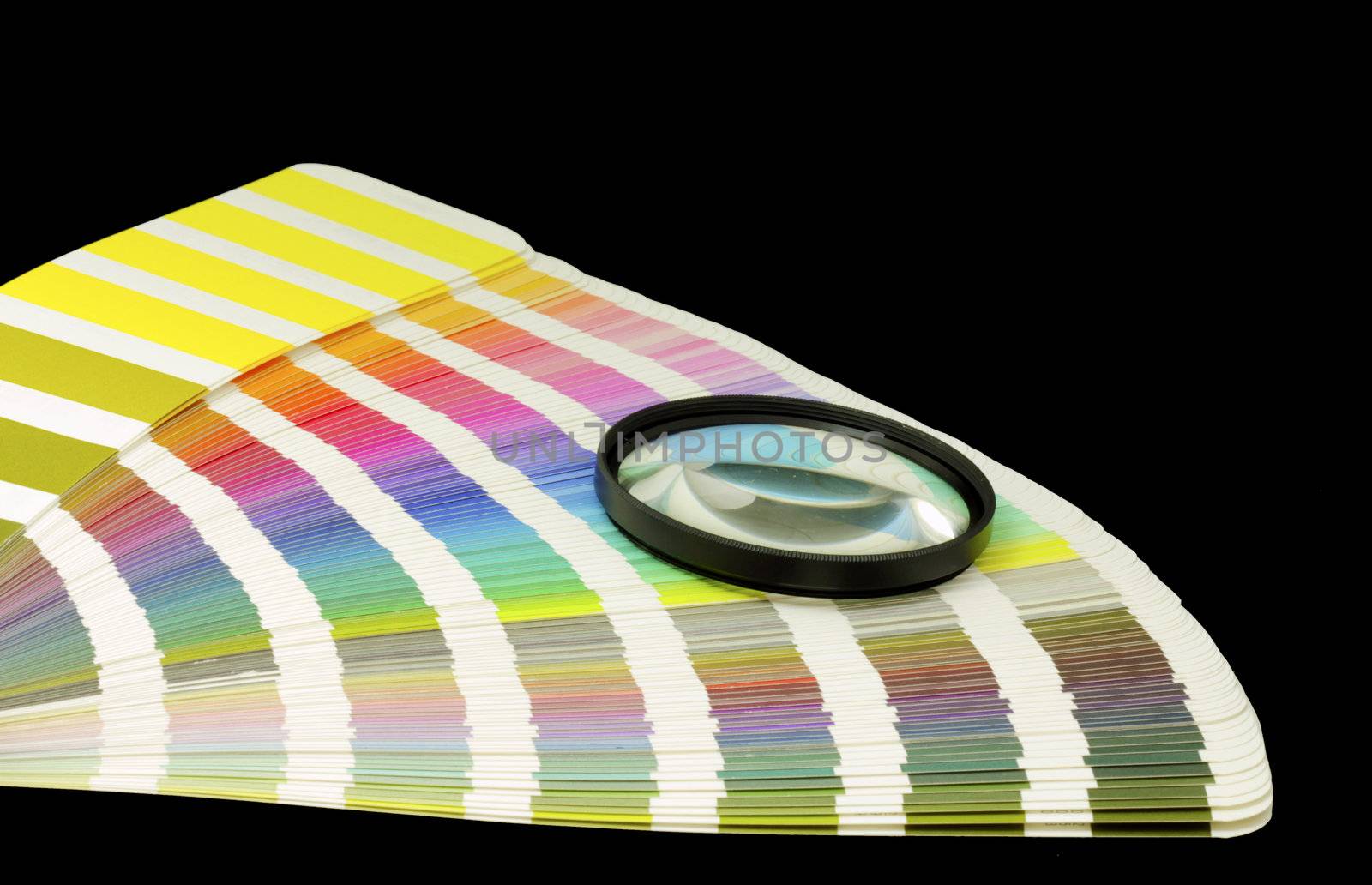 Color guide for offset print with a magnifier lens over the table