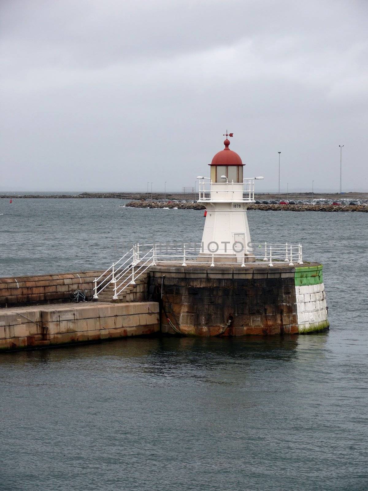 portrait of an old lighthouse on gray sky