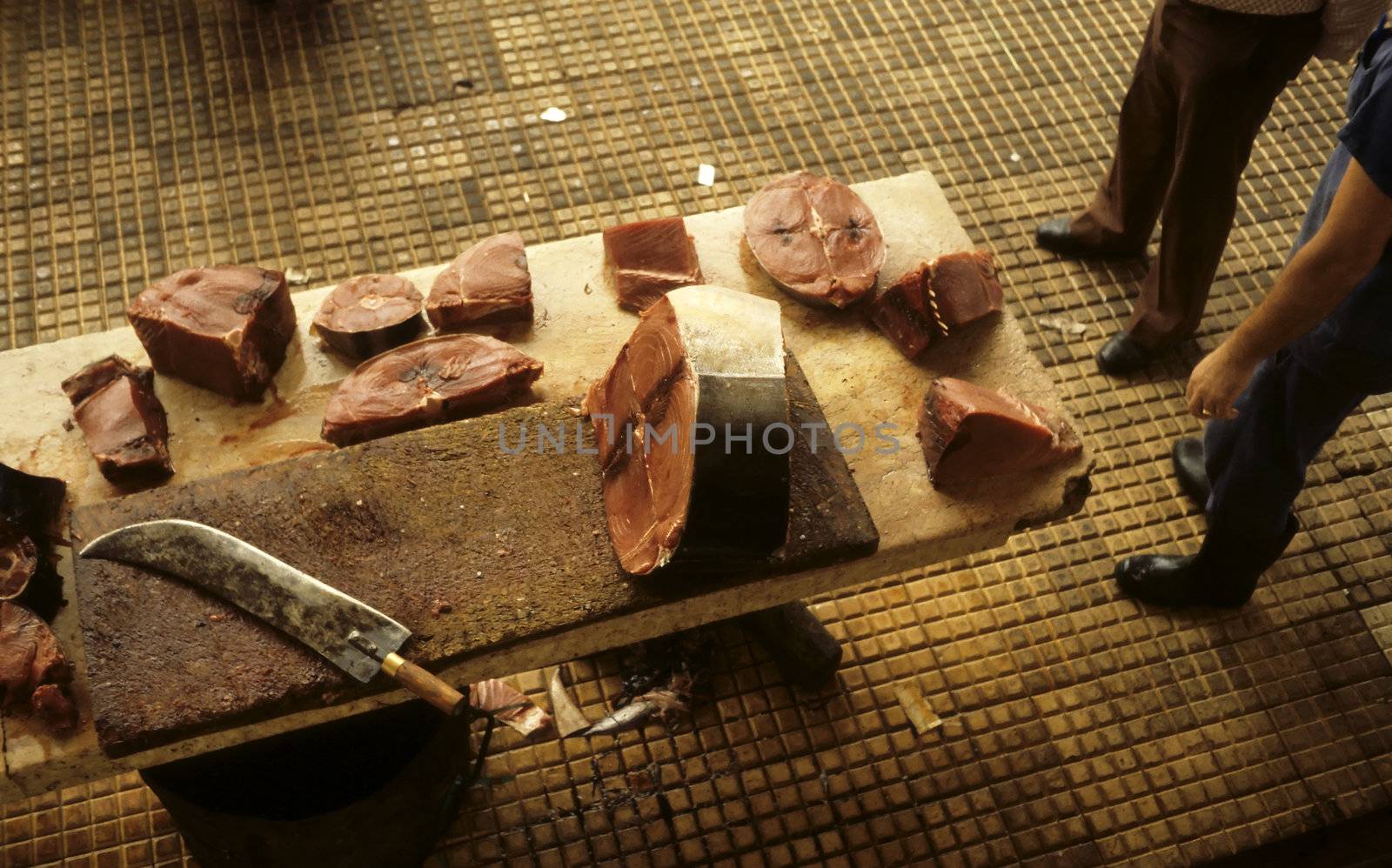 Slabs of fish on a wooden table in a fish market