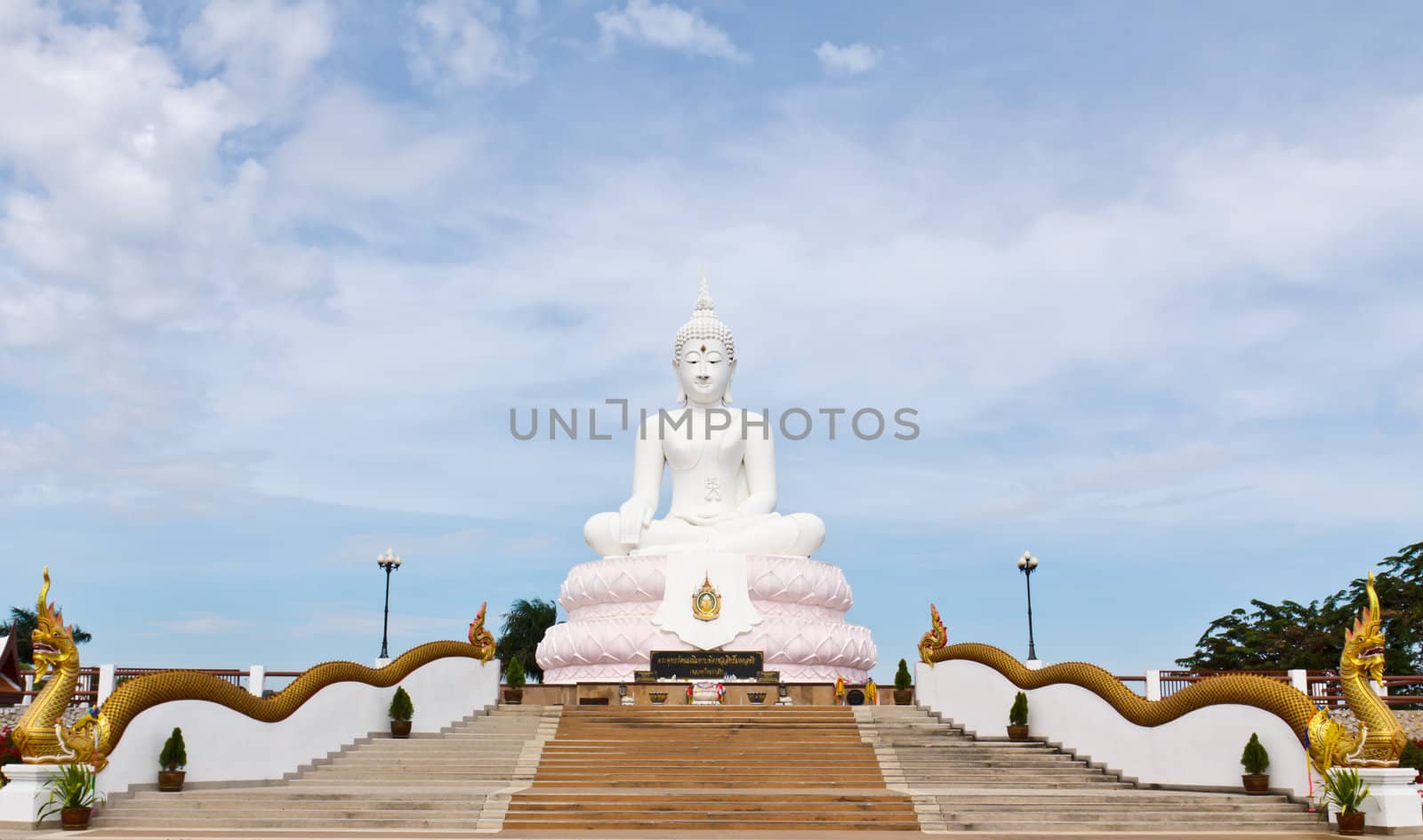 White Buddha statue with blue sky.