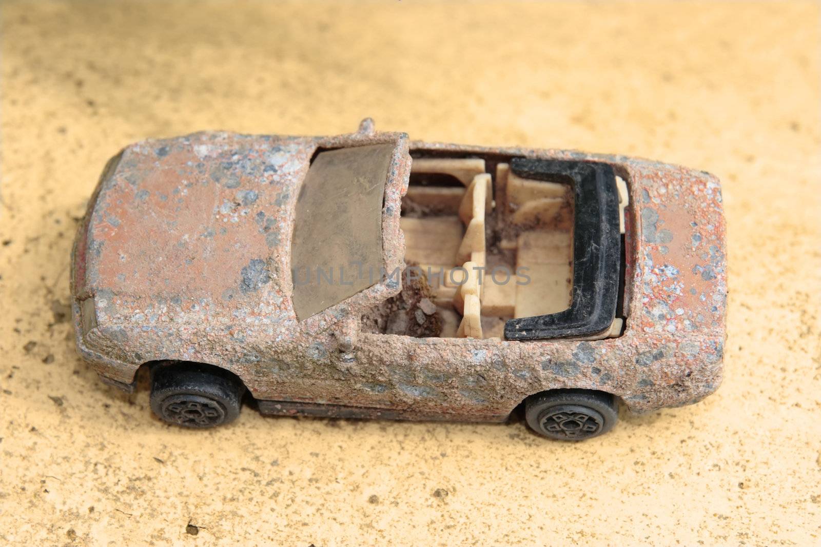 an old rusty toy classic car close up from above