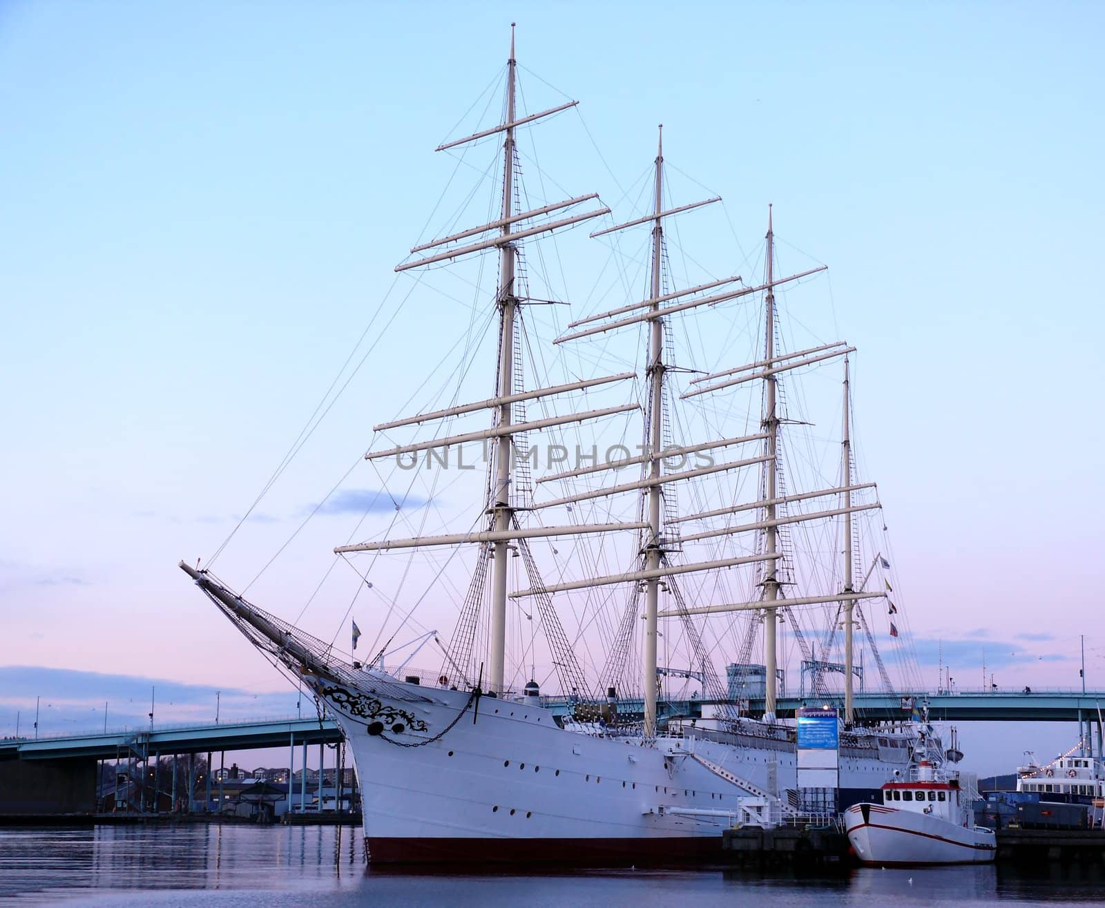 portrait of sail ship in the harbour in beautiful sunset