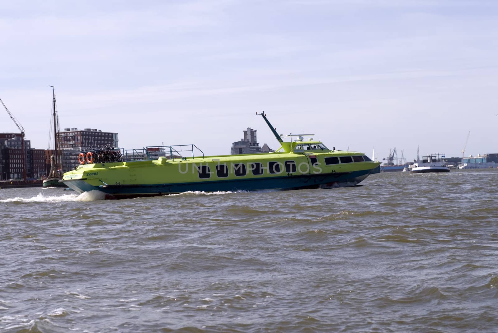 portrait of an green boat outside amsterdam canal 