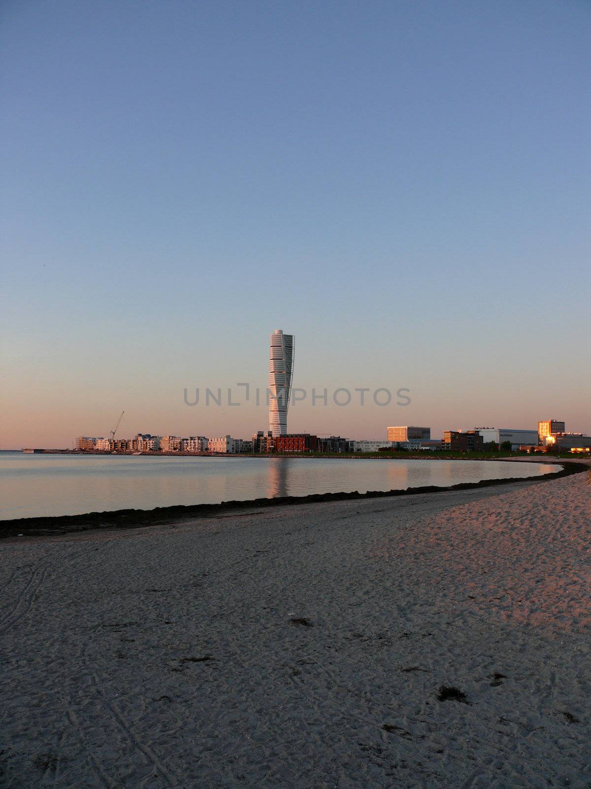 portrait of turning tower building with reflections in water