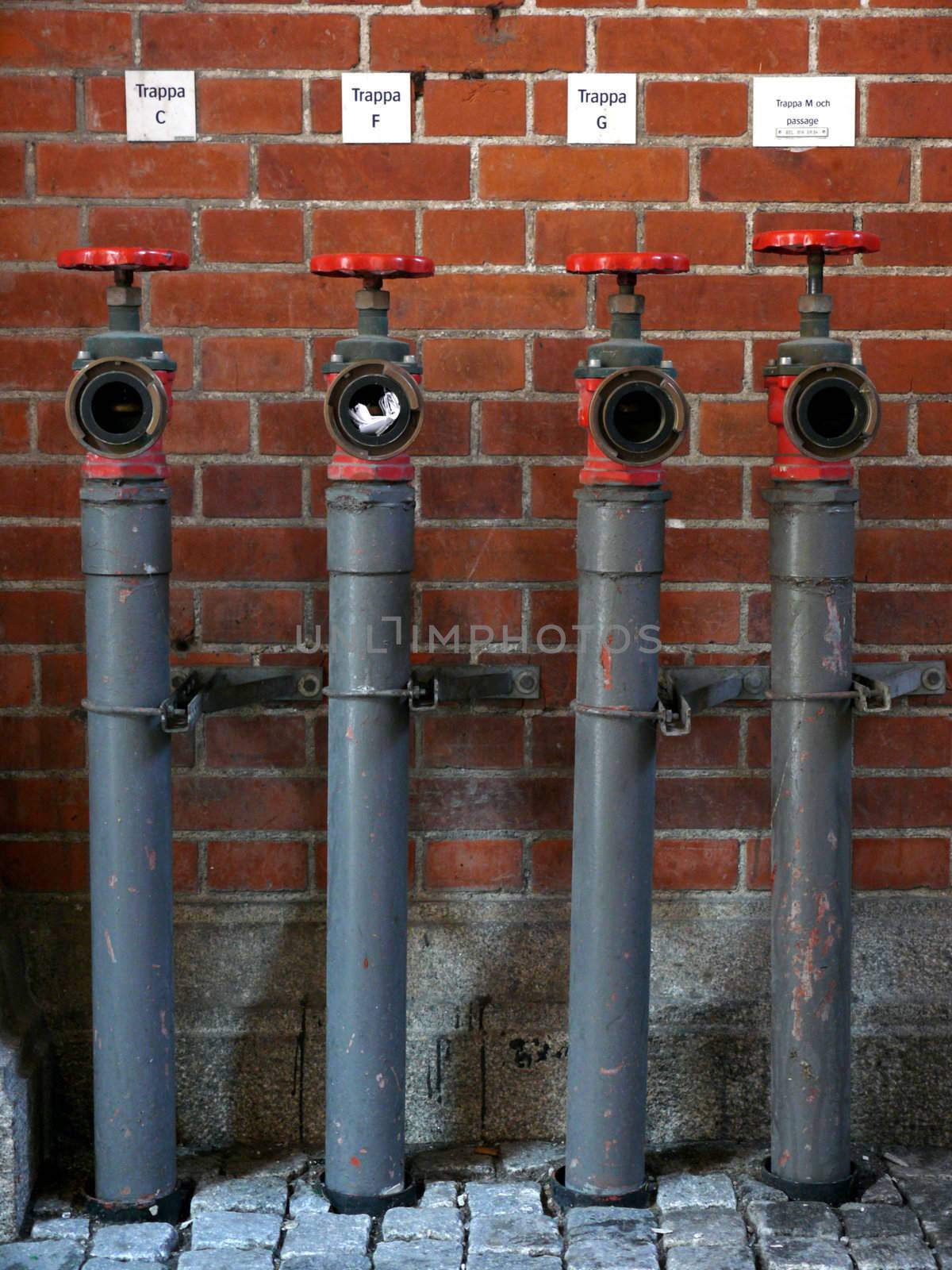 portrait of row of water pipes with a note