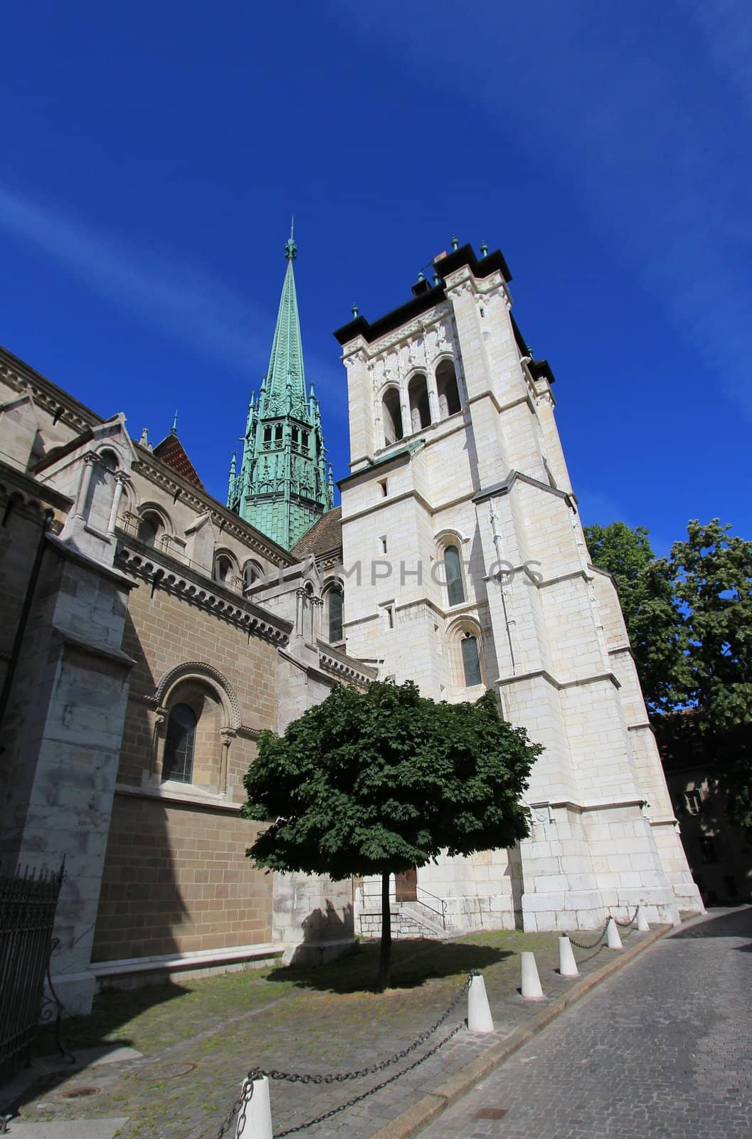 Side of protestant Saint-Peter's cathedral in Geneva, Switzerland, by beautiful weather. The construction started in 1160 and lasted about one century. After that, it's been modified several times, sometimes because of fire. At XVI century, when the protestant Reformation advented, the inside was modified to have less decoration.