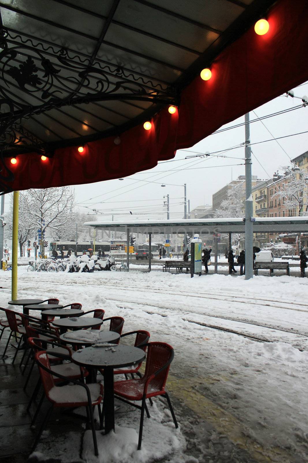 Tables and chairs at a pub at Plainpalais place by winter, Geneva, Switzerland.