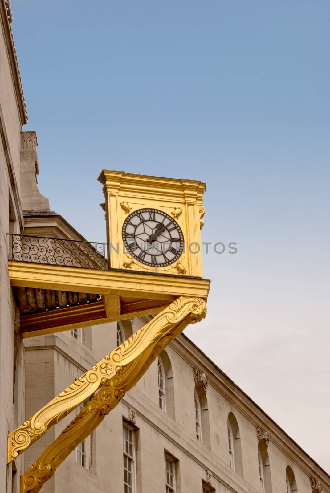 A Gold Coloured Clock on the side of a building in Yorkshire England