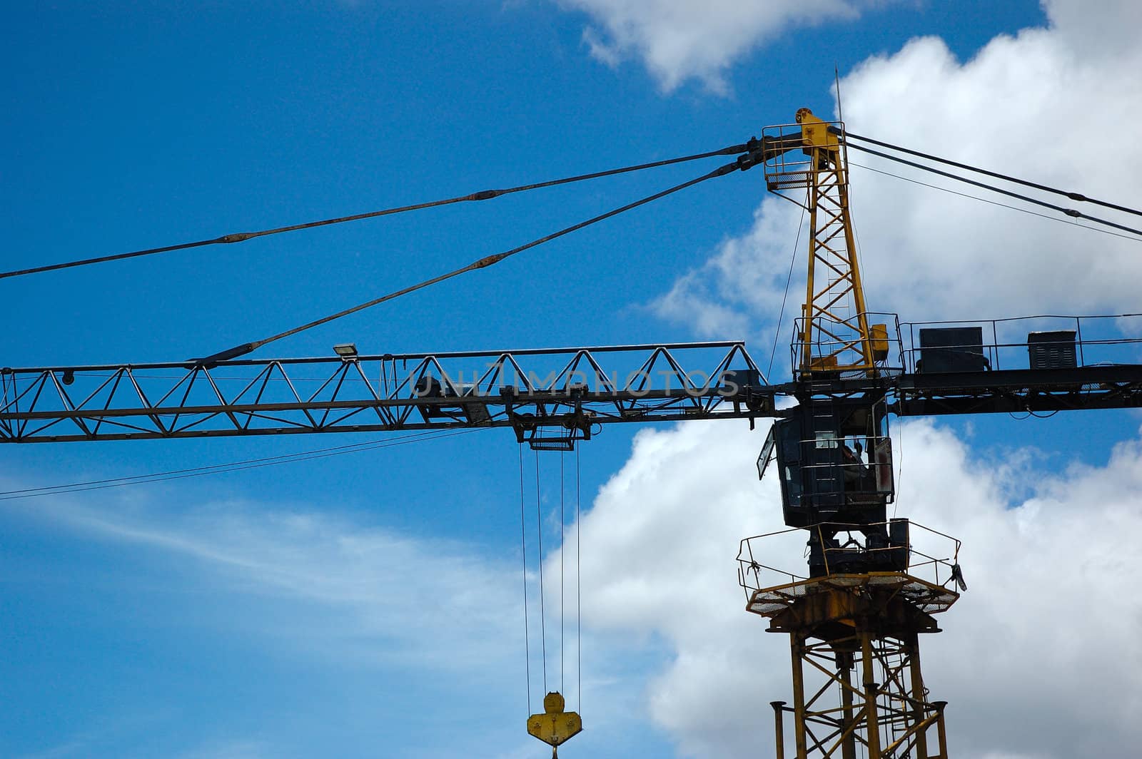 heavy industrial crane with blue sky as background