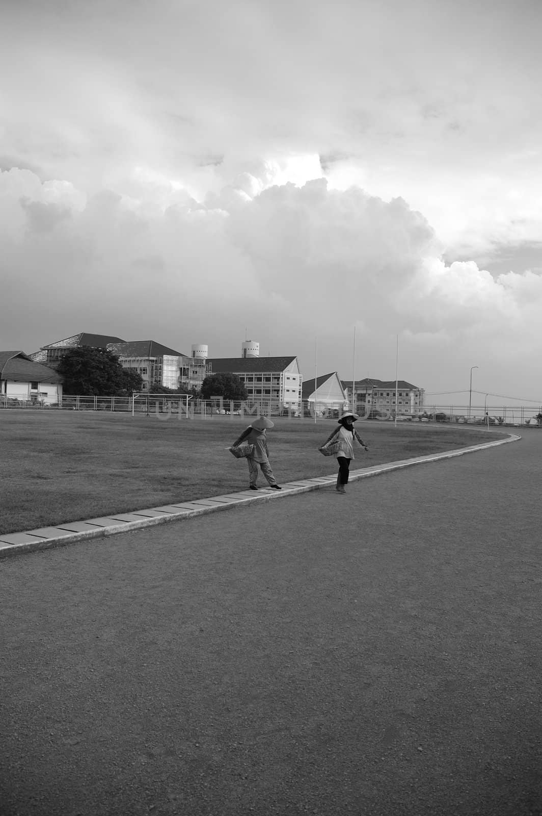 indonesian farmer back from work accross the field