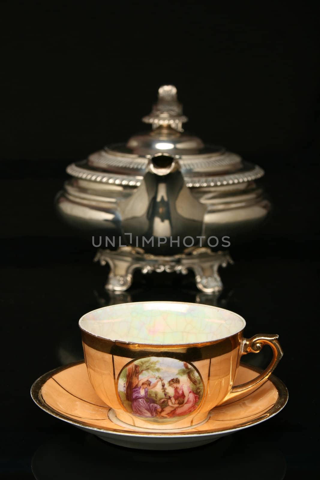 Silver teapot and an antique chinese cup of tea by Erdosain