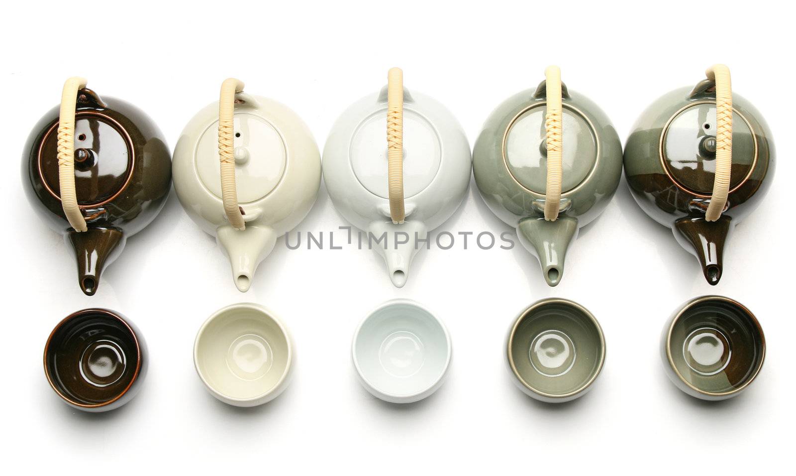 Various teapots and tea cups over white background