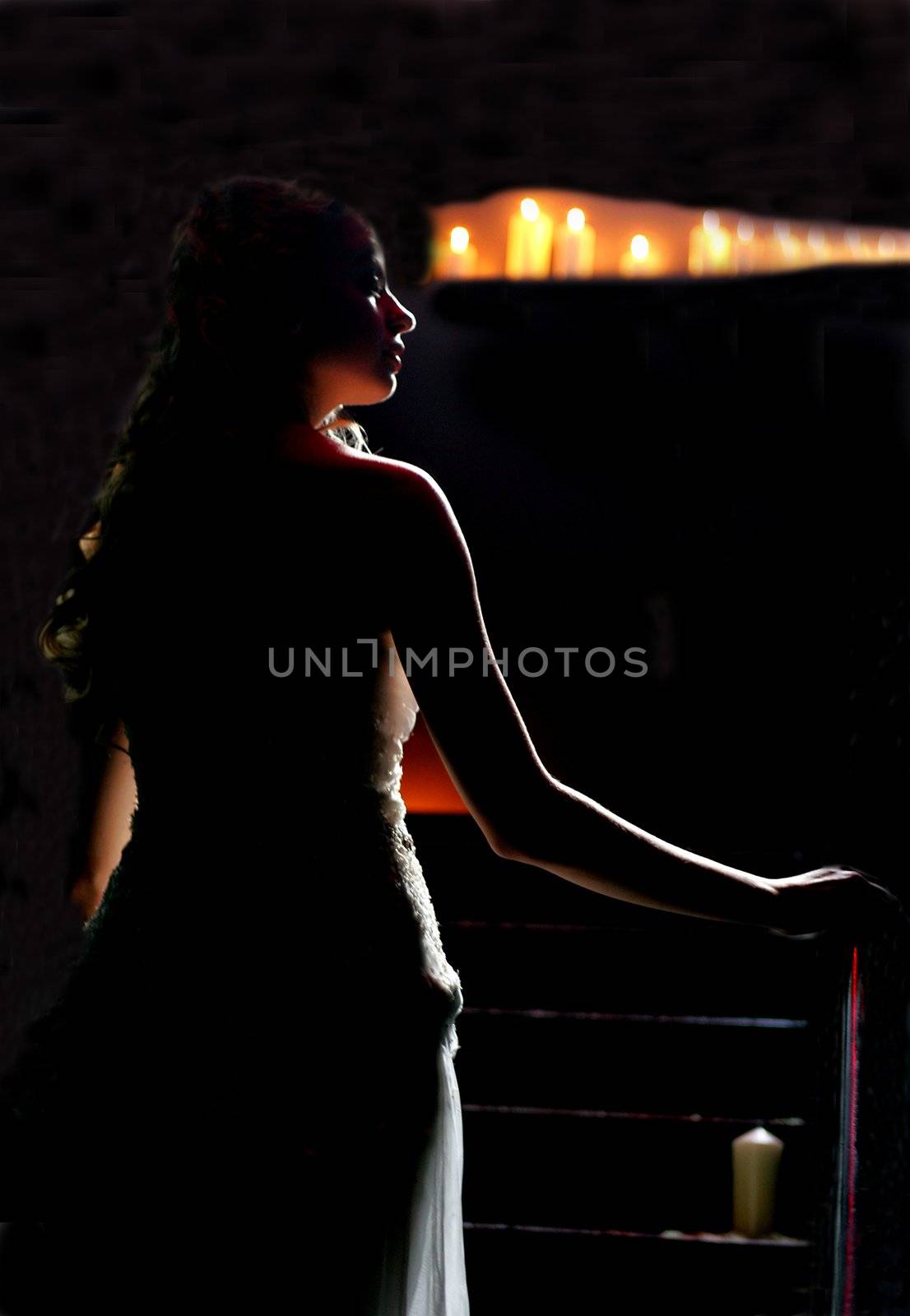 Woman walking in candlelit church by speedfighter