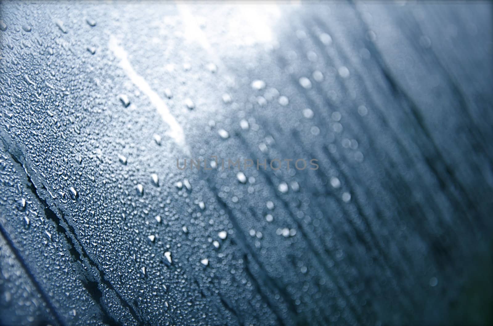 Water droplets collect on a window in the morning in Colorado.