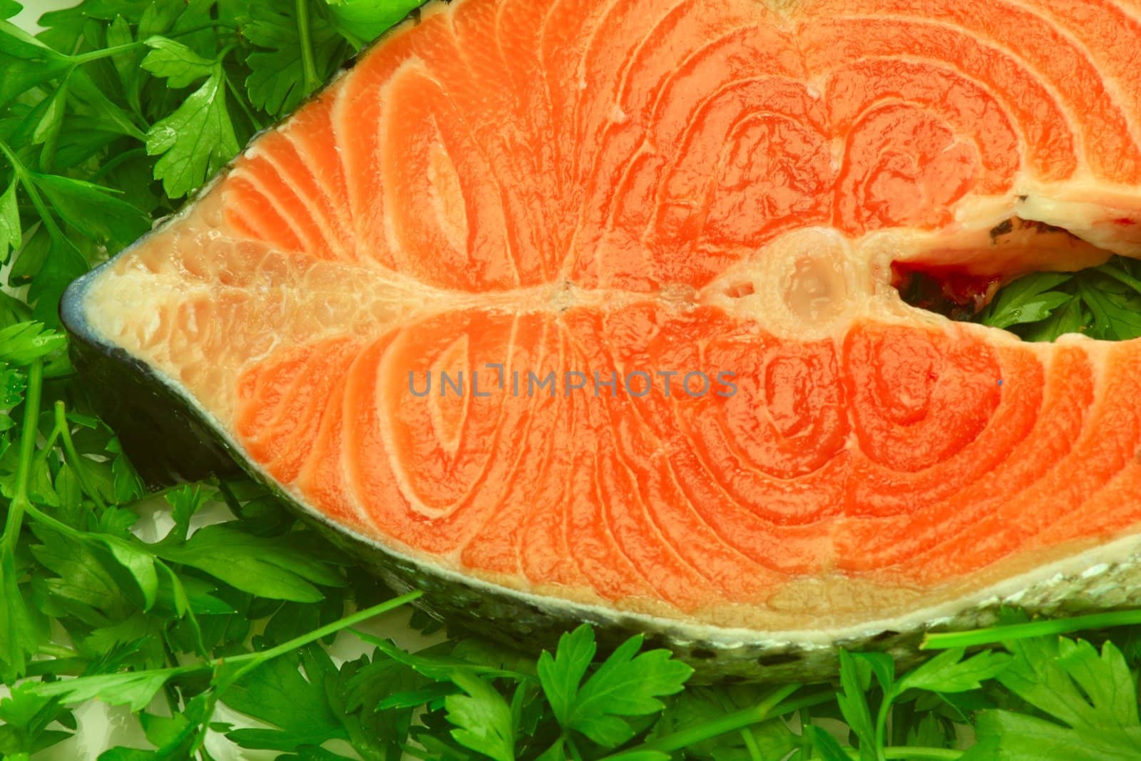 Fresh salmon steak on the salad leaf