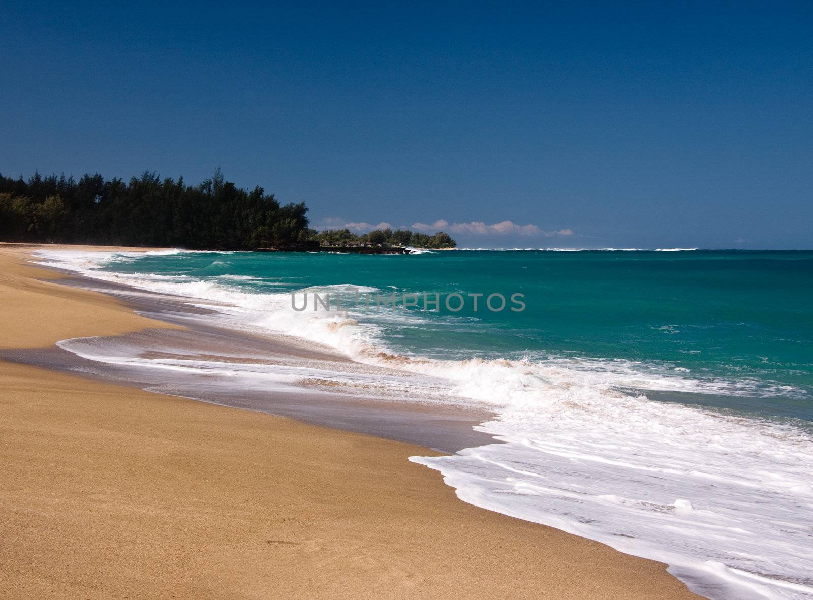 Waves breaking onto Lumaha'i beach on the north coast of Kauai