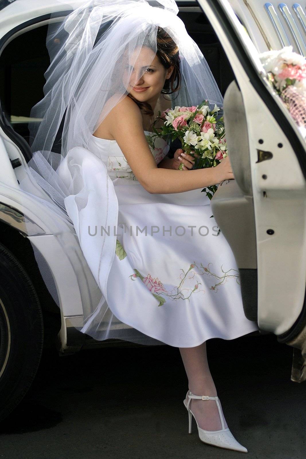 Smiling bride in wedding car limo by speedfighter