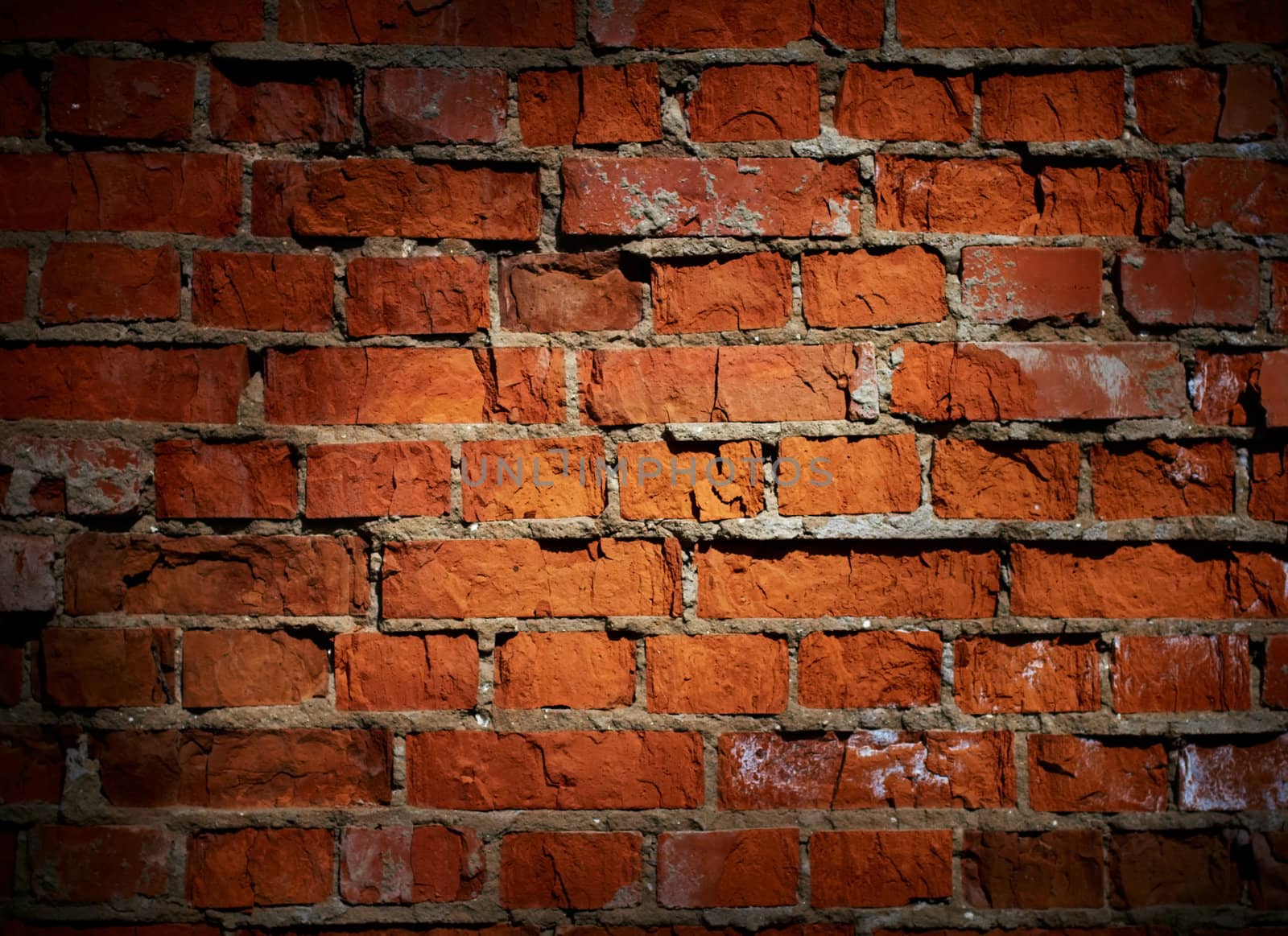 Weathered stained old brick wall background 
